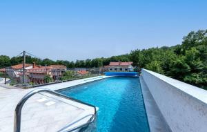 a swimming pool with blue water on top of a house at Villa Mihaela by Villas Guide in Rukavac