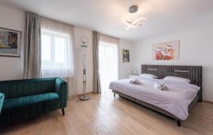 a bedroom with a bed and a green couch at Villa Mihaela by Villas Guide in Rukavac +30 photos