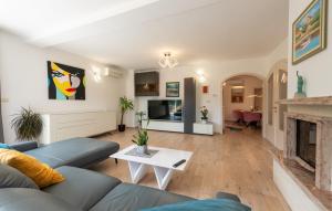 a living room with a blue couch and a fireplace at Villa Mihaela by Villas Guide in Rukavac