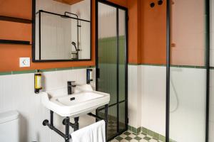 a bathroom with a sink and a shower at Honest Sevilla Hotel in Seville