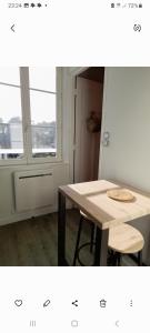 a room with a table and a table and a window at Les roses à la plage in Veules-les-Roses +29 photos