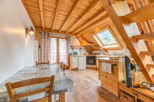 a kitchen with wooden ceilings and a table in a room at Auberge Passoud 203 in Vaujany
