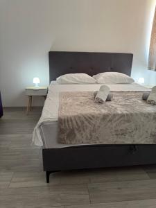a bedroom with a bed with two towels on it at Apartments Lucijan Međugorje in Međugorje