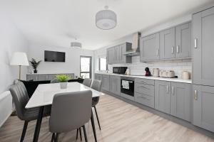 a kitchen with a table and chairs in a room at North Dublin Homestay in Dublin