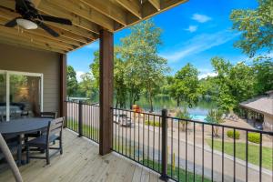 a screened porch with a table and a view of a lake at New Lakeside Haven - Picturesque in Branson