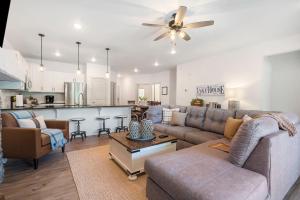 a living room with a couch and a kitchen at New Lakeside Haven - Picturesque in Branson +22 photos
