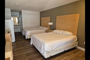 a bedroom with two beds and a room with at General Bragg Inn & Suites Chickamauga in Chickamauga