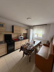 a kitchen with a table and a dining room at Casa Dany in Vatra Dornei