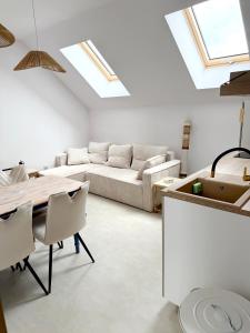 a living room with a couch and a table at Apartament Szyszka in Rogowo +13 photos