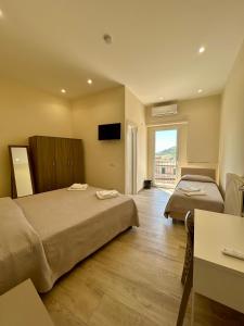 a hotel room with two beds and a television at B&b Al Centro Nicosia in Nicosia
