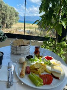 a plate of food on a table with a plate of food at Harmony Blue Pansiyon in Burhaniye