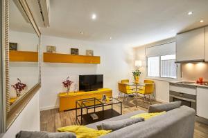 a living room with a couch and a table at BBarcelona Sant Pau Flat in Barcelona