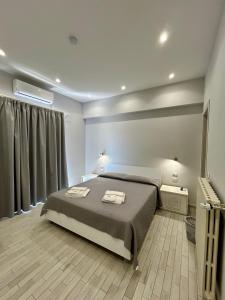 a bedroom with a bed with two towels on it at B&b Al Centro Nicosia in Nicosia