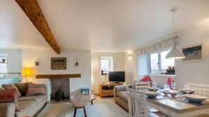 a living room with a couch and a table at Sundeck in Brixham