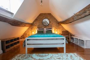 a bedroom with a bed in a attic at Exquisite Historic Hideaway in Bradford on Avon