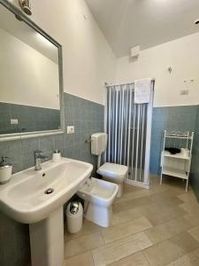 a bathroom with a sink and a toilet and a mirror at B&b Al Centro Nicosia in Nicosia