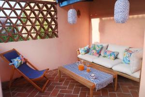 a living room with a couch and a table and a chair at Casa do Limoeiro - sleeps up to 4 comfortably in Serpa