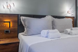 a bedroom with a bed with towels on it at Aurelia Garden Suite in Rome