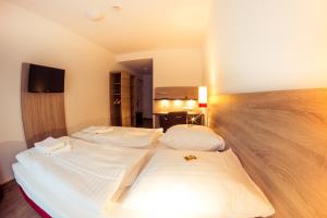 a bedroom with two beds in a room at guestified MILO NOEL Hotel in Bonn +13 photos