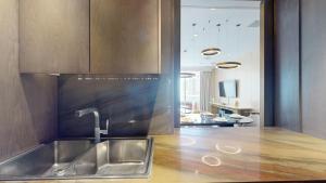 a kitchen with a sink and a counter top at Vacationer Holiday Homes I Opulent 2 Bedroom I Sea View I Beach Access l FIVE Palm in Dubai