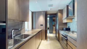 a kitchen with a sink and a counter top at Vacationer Holiday Homes I Opulent 2 Bedroom I Sea View I Beach Access l FIVE Palm in Dubai