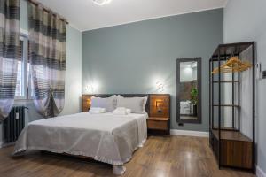 a bedroom with a bed and a mirror at Aurelia Garden Suite in Rome