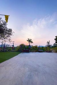a park with a playground with a sunset in the background at Bonkao Sawan Café in Ban Khlot