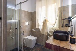 a bathroom with a shower and a black bath tub at Aurelia Garden Suite in Rome