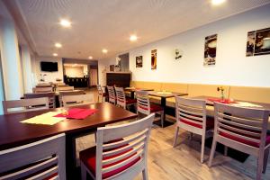 a dining room with wooden tables and chairs at guestified MILO NOEL Hotel in Bonn