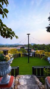 a view of a yard with a field of flowers at Baan Bonkao Resort Sattahip in Ban Khlot +37 photos