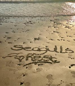 a word written in the sand on a beach at Seagulls Rest in Isle of Wight