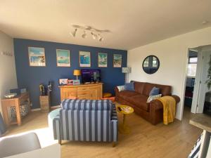 a living room with a couch and a chair at Seagulls Rest in Isle of Wight
