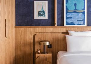 a bedroom with a bed and a table with a lamp at La Fondation in Paris
