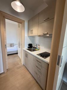 a kitchen with a sink and a counter top at Korelis Apartments in Ayia anna