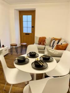 a living room with a white table and white chairs at Edinburgh City Centre Oasis in Edinburgh
