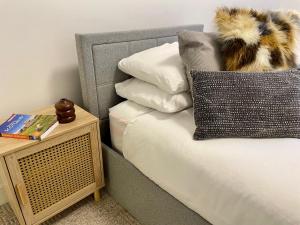 a bed with a pillow and a side table at Edinburgh City Centre Oasis in Edinburgh