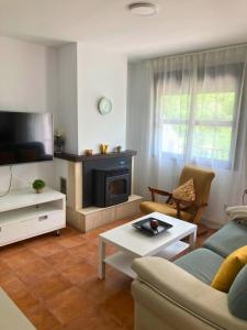 a living room with a couch and a fireplace at Mirador del Ángel in Cazorla