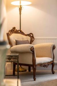 a living room with a chair and a lamp at Central, beautiful home - with parking in Bradford on Avon