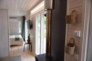 a house with a wood stove in a room at Stuga med strandbastu in Oravais