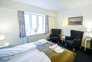 Postel nebo postele na pokoji v ubytování Dronninglund Hotel