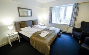 Postel nebo postele na pokoji v ubytování Dronninglund Hotel