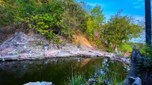 a painting of a pond in a garden at Bonkao Sawan Café in Ban Khlot