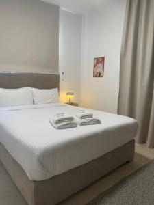 a bedroom with a large bed with white sheets at Kroisou Comfort Stay in Ayios Dhometios +9 photos