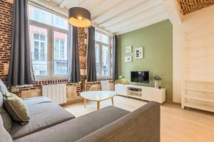 a living room with a couch and a table at Old Town - Superb apartment in rue Esquermoise ! in Lille