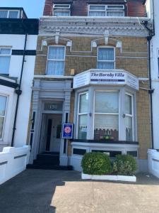 a store front of a brick building with a window at Hornby Villa- 4Star B&B-Couples & Families Only in Blackpool +32 photos