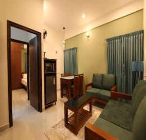a living room with a couch and a chair at Olivette Suites in Bangalore