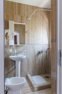 a bathroom with a sink and a toilet and a shower at Apartments Donna in Bar +46 photos