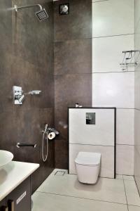 a bathroom with a shower with a toilet and a sink at Banbury Bungalow in Kanthalloor