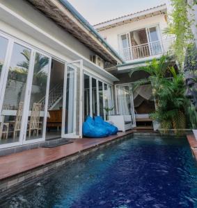 a house with a swimming pool in front of a house at Private-Pool Family Villa near Canggu Beach in Tumbak Bayuh