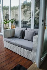 a wicker couch sitting on a porch at Private-Pool Family Villa near Canggu Beach in Tumbak Bayuh